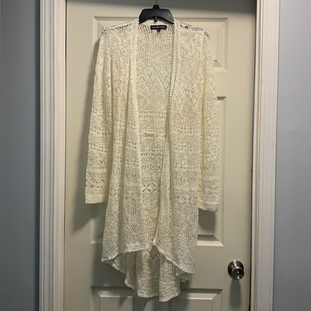 Cream colored long open cardigan.